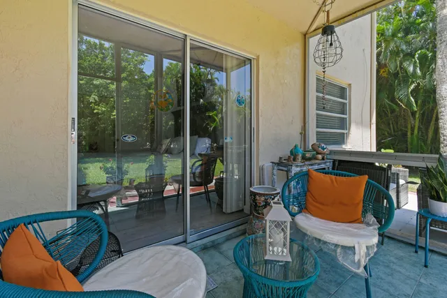a balcony with furniture and a potted plant