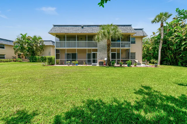 a front view of a building with a garden