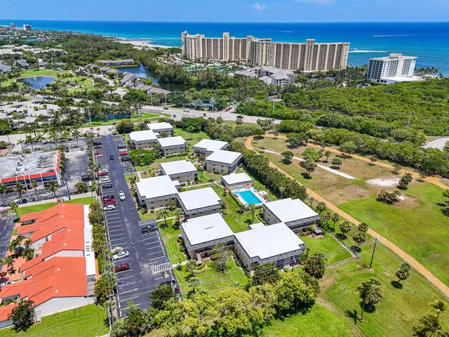an aerial view of multiple houses with yard