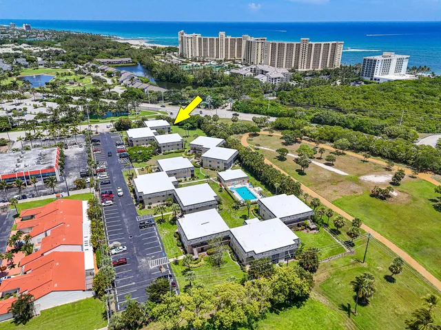 an aerial view of multiple houses with yard