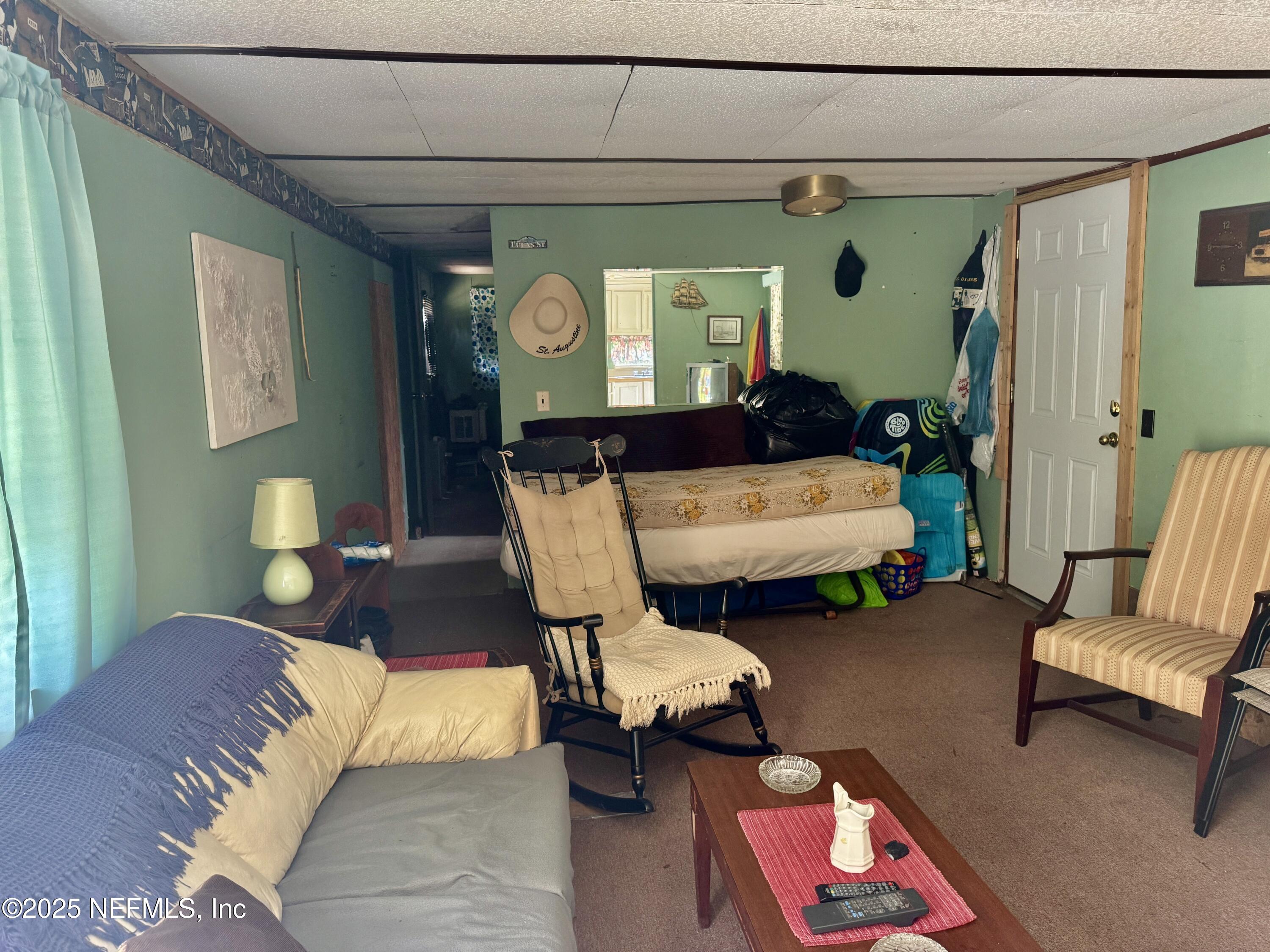 267 Lakeview Court Interlachen, FL 32148 - Photo 6 of 10 a living room with furniture and a mirror