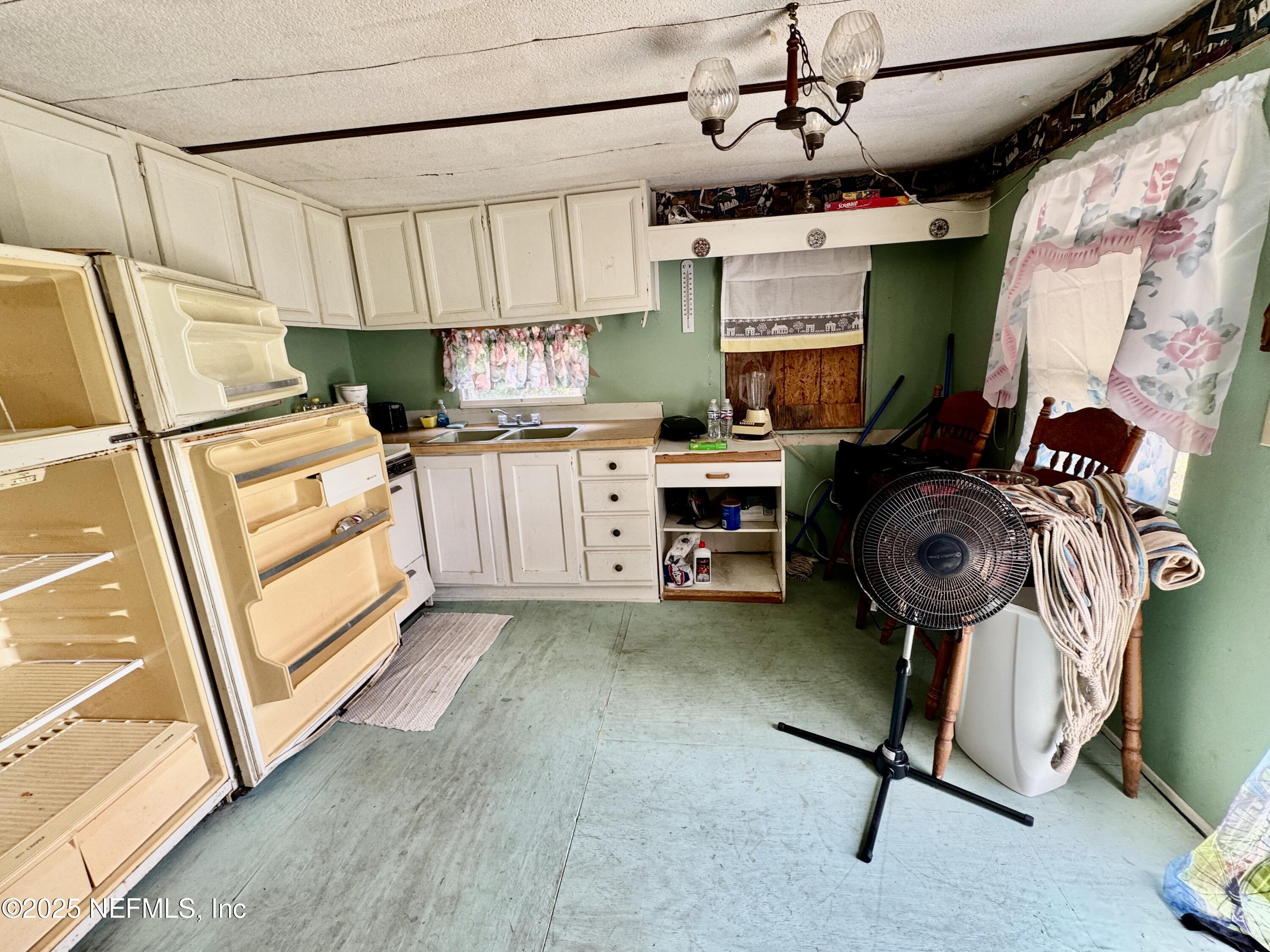 267 Lakeview Court Interlachen, FL 32148 - Photo 7 of 10 a kitchen with kitchen island stainless steel appliances a stove a sink and a refrigerator