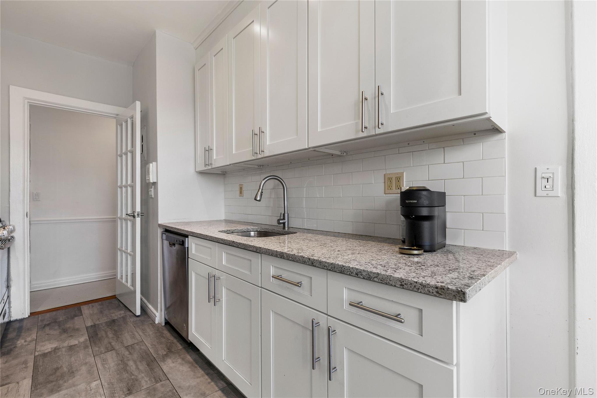 11 Alden Road, Unit 6L Larchmont, NY 10538 - Photo 14 of 22 a kitchen with granite countertop white cabinets and a sink