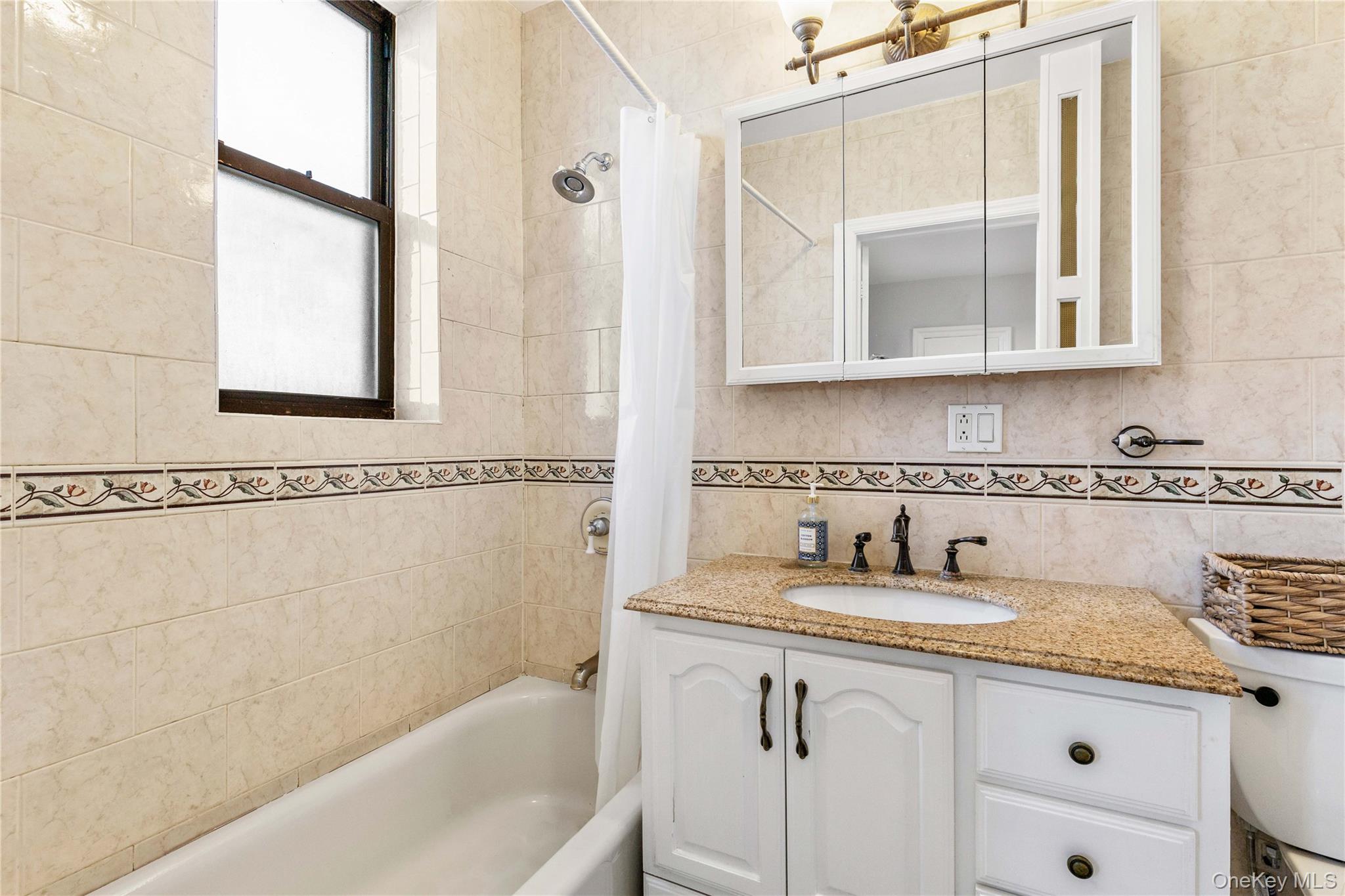 11 Alden Road, Unit 6L Larchmont, NY 10538 - Photo 17 of 22 a bathroom with a granite countertop sink and a bathtub