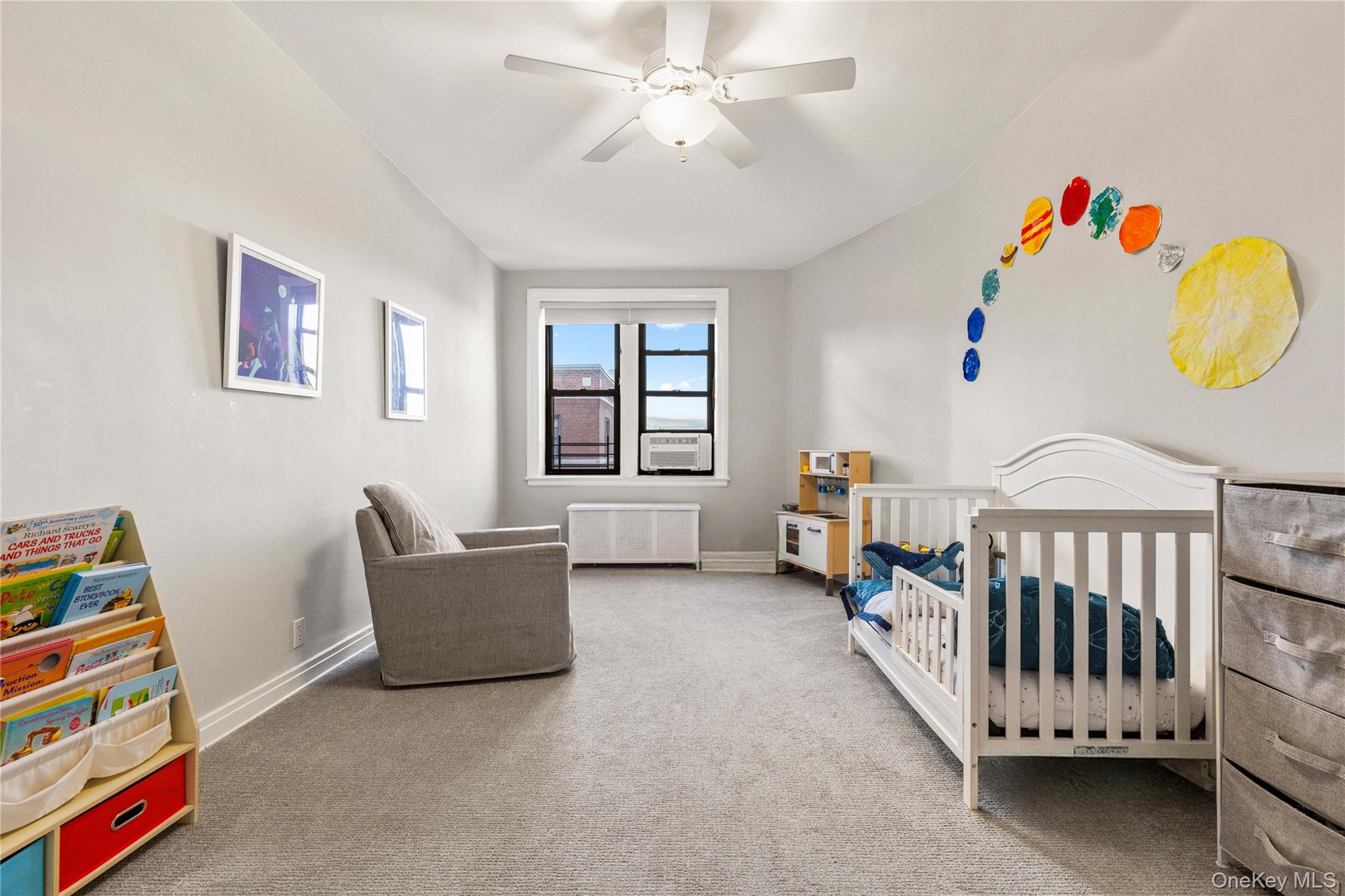 11 Alden Road, Unit 6L Larchmont, NY 10538 - Photo 19 of 22 a living room with baby crib furniture and a window
