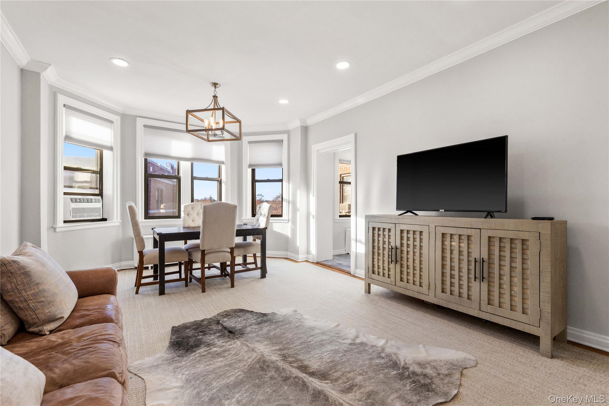 11 Alden Road, Unit 6L Larchmont, NY 10538 - Photo 10 of 22 a living room with furniture and a flat screen tv