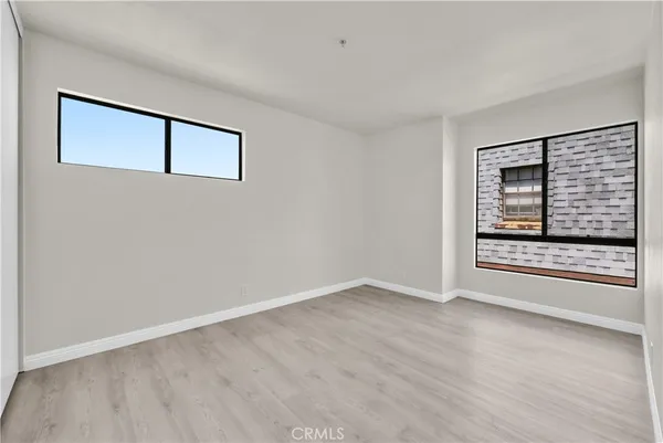 a view of an empty room with a fireplace and a window