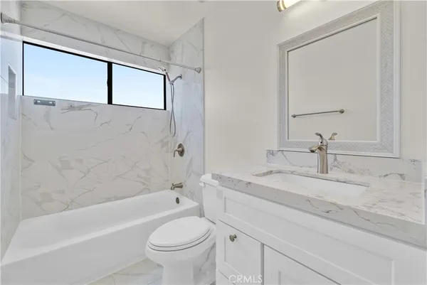 a bathroom with a sink a toilet and a bathtub