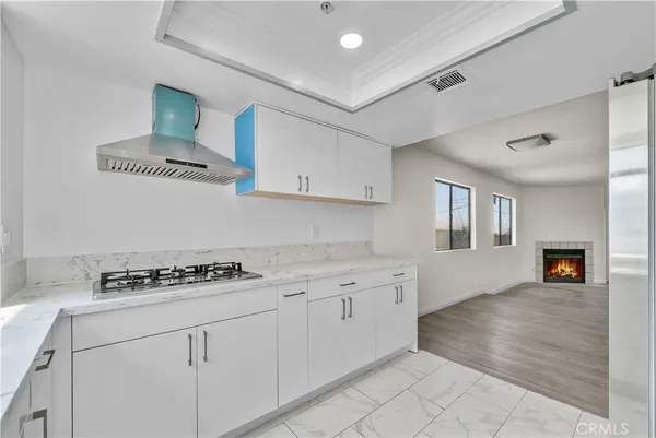 a kitchen with granite countertop a stove sink and cabinets