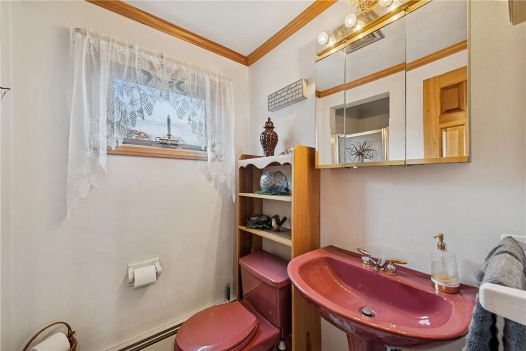 2052 Ridge Road Jeannette, PA 15644 - Photo 13 of 39 a bathroom with a sink mirror and toilet