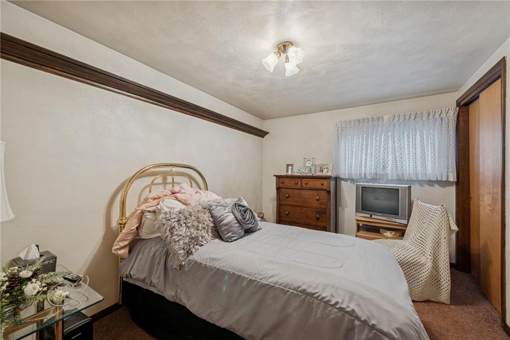 2052 Ridge Road Jeannette, PA 15644 - Photo 23 of 39 a bedroom with a bed and a tv