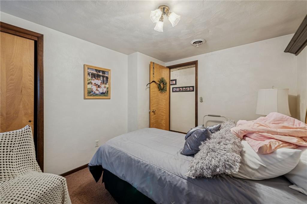 2052 Ridge Road Jeannette, PA 15644 - Photo 24 of 39 a bedroom with a large bed and a chandelier