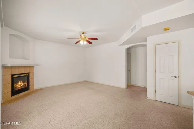 a view of an empty room with a fireplace