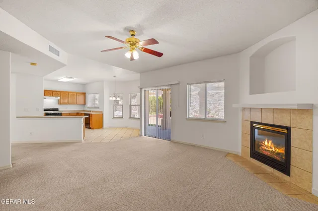 a view of an empty room with window and fireplace