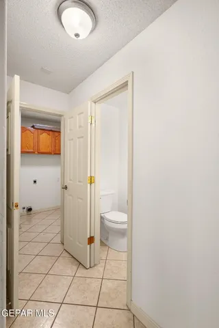 a bathroom with a granite countertop sink a toilet and a shower