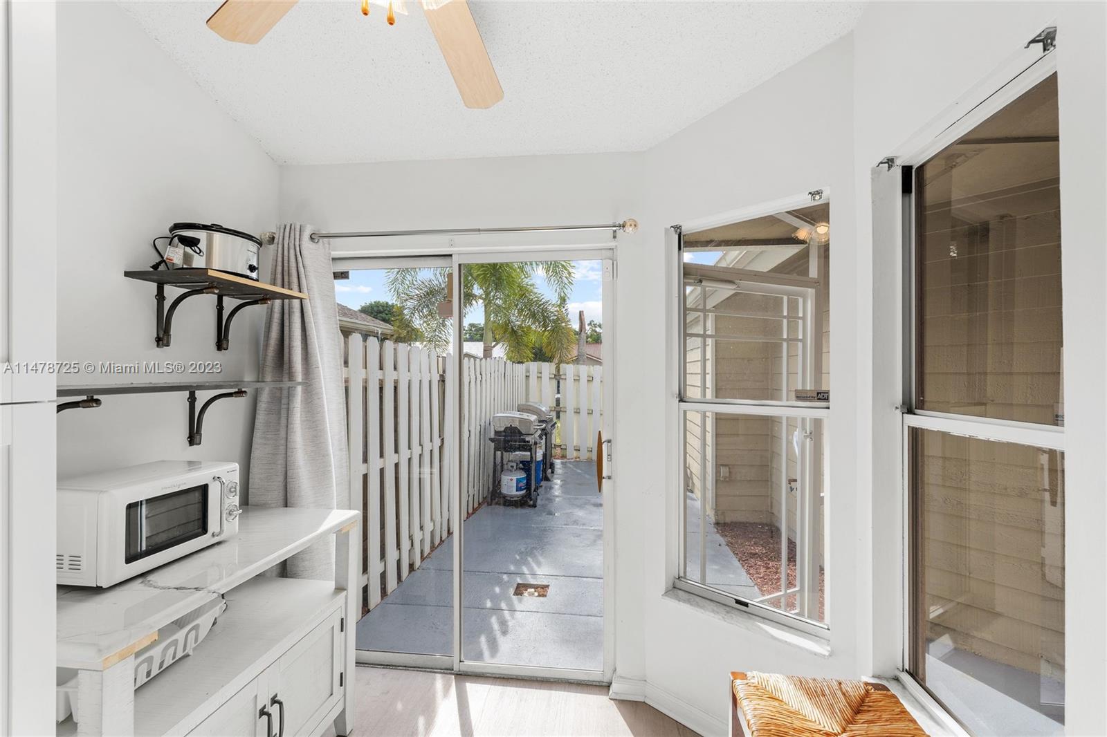 12722 Westhampton Circle Wellington, FL 33414 - Photo 13 of 52 a view of a livingroom with a fireplace a ceiling fan and windows