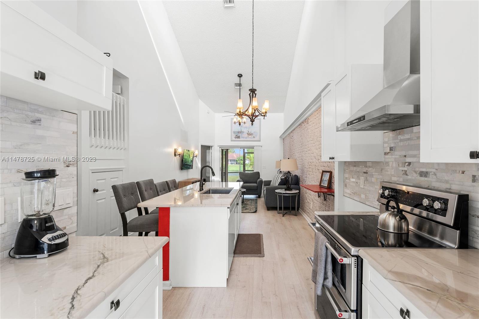 12722 Westhampton Circle Wellington, FL 33414 - Photo 15 of 52 a living room with furniture and a chandelier