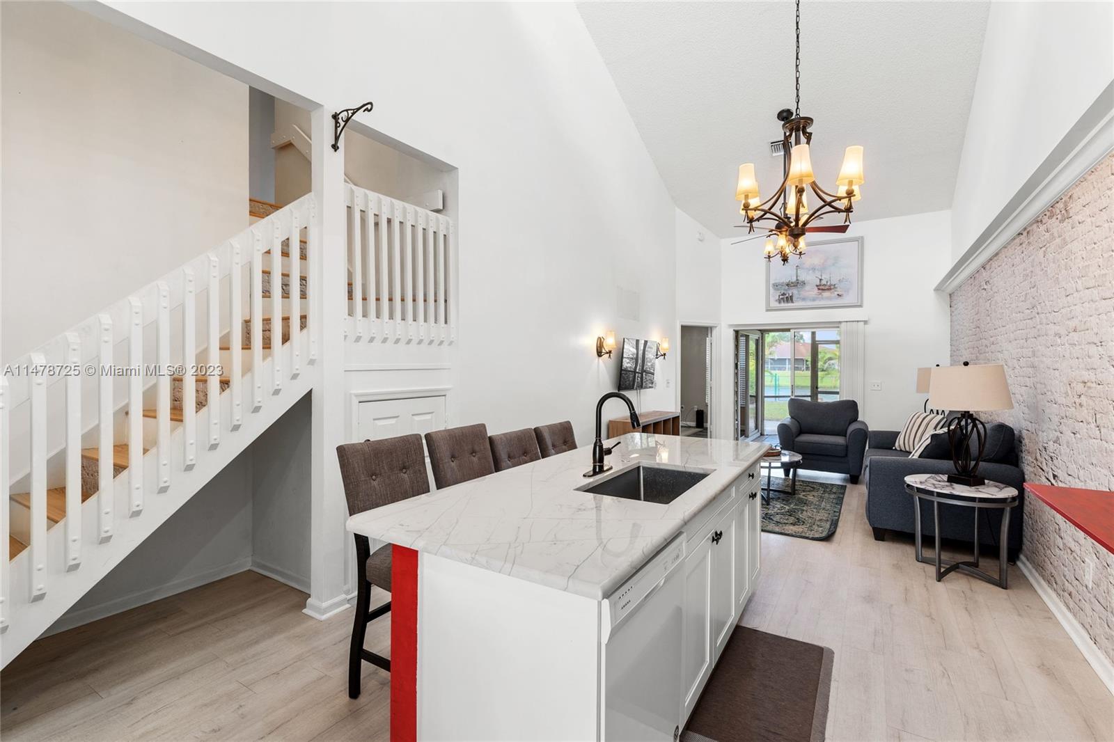 12722 Westhampton Circle Wellington, FL 33414 - Photo 17 of 52 a kitchen that has a lot of cabinets in it