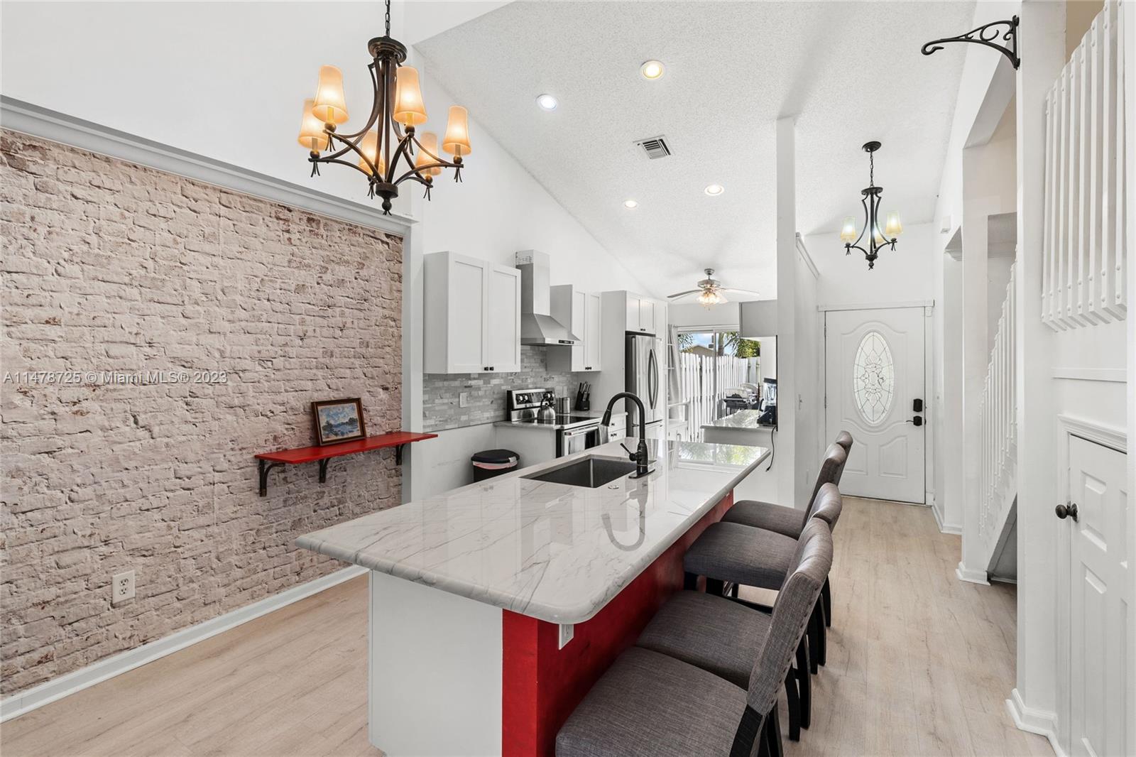 12722 Westhampton Circle Wellington, FL 33414 - Photo 20 of 52 a living room with patio furniture and a fireplace