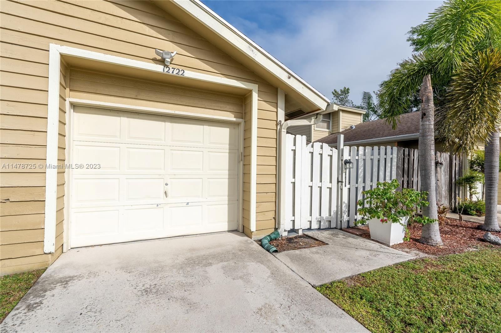 12722 Westhampton Circle Wellington, FL 33414 - Photo 2 of 52 a front view of a house with a garage