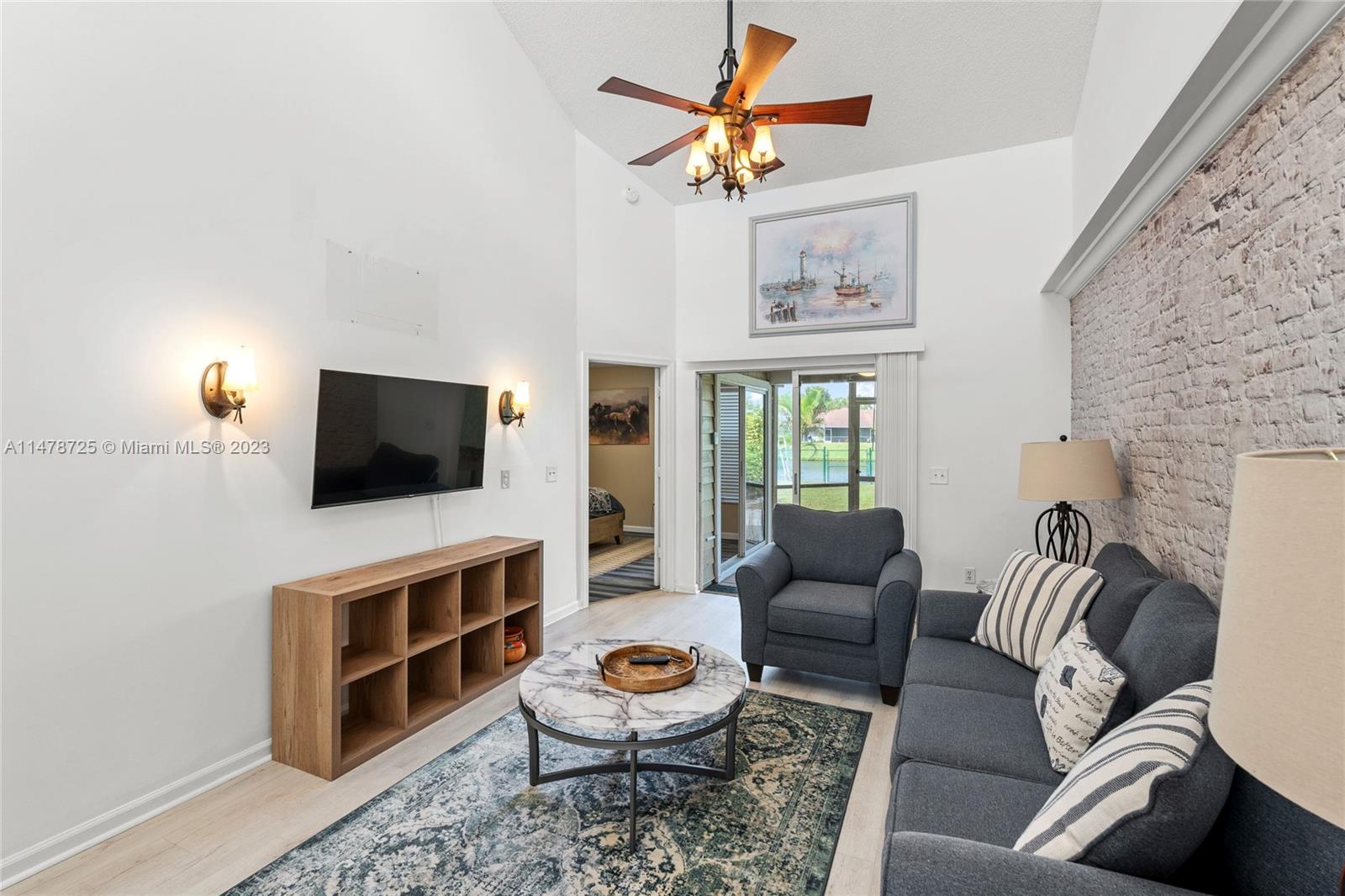 12722 Westhampton Circle Wellington, FL 33414 - Photo 22 of 52 a living room with furniture and a flat screen tv