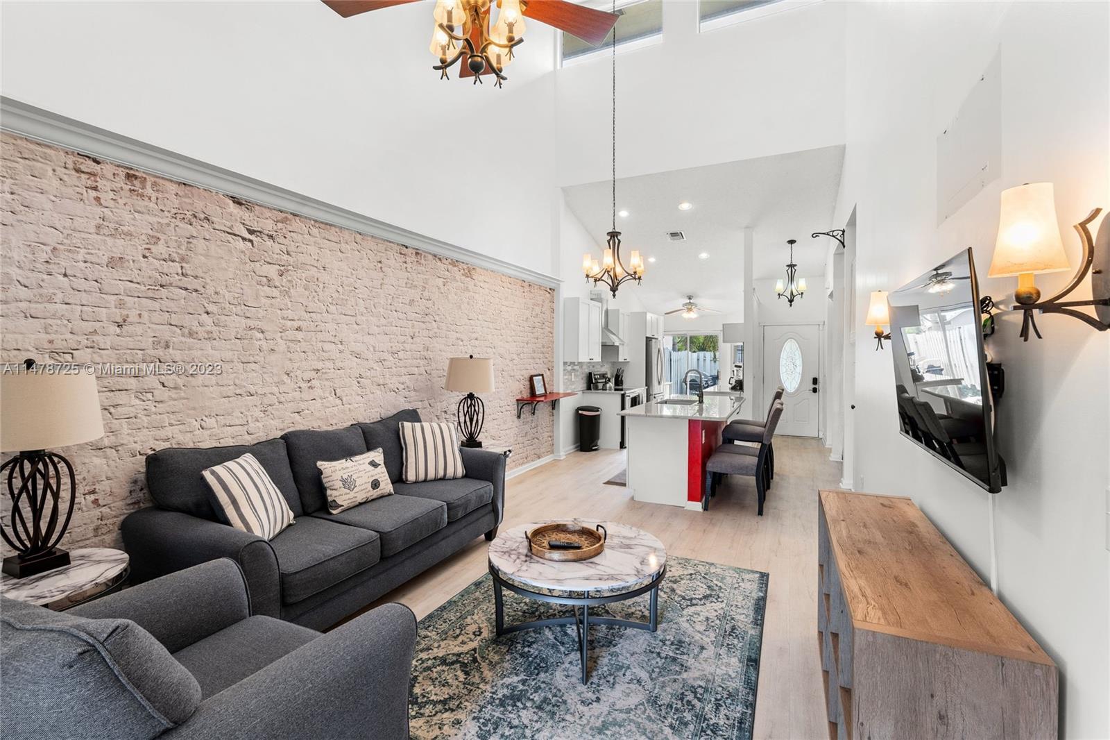 12722 Westhampton Circle Wellington, FL 33414 - Photo 23 of 52 a living room with furniture and a flat screen tv