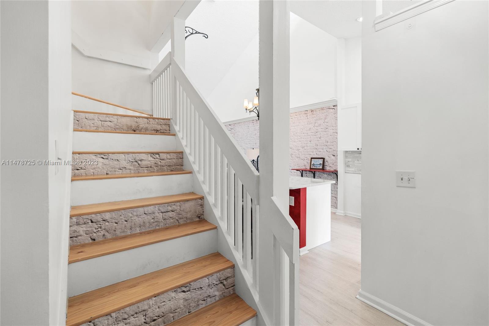 12722 Westhampton Circle Wellington, FL 33414 - Photo 25 of 52 a view of staircase with wooden floor and a rug