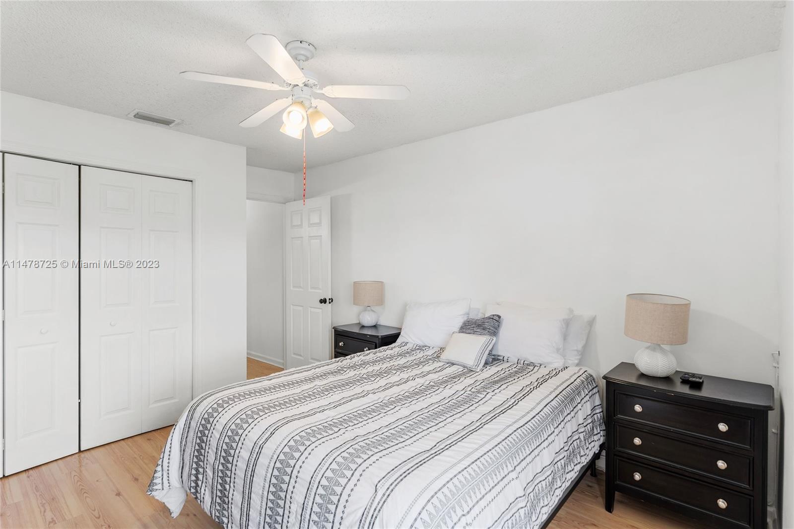 12722 Westhampton Circle Wellington, FL 33414 - Photo 27 of 52 a bedroom with a bed and a dresser