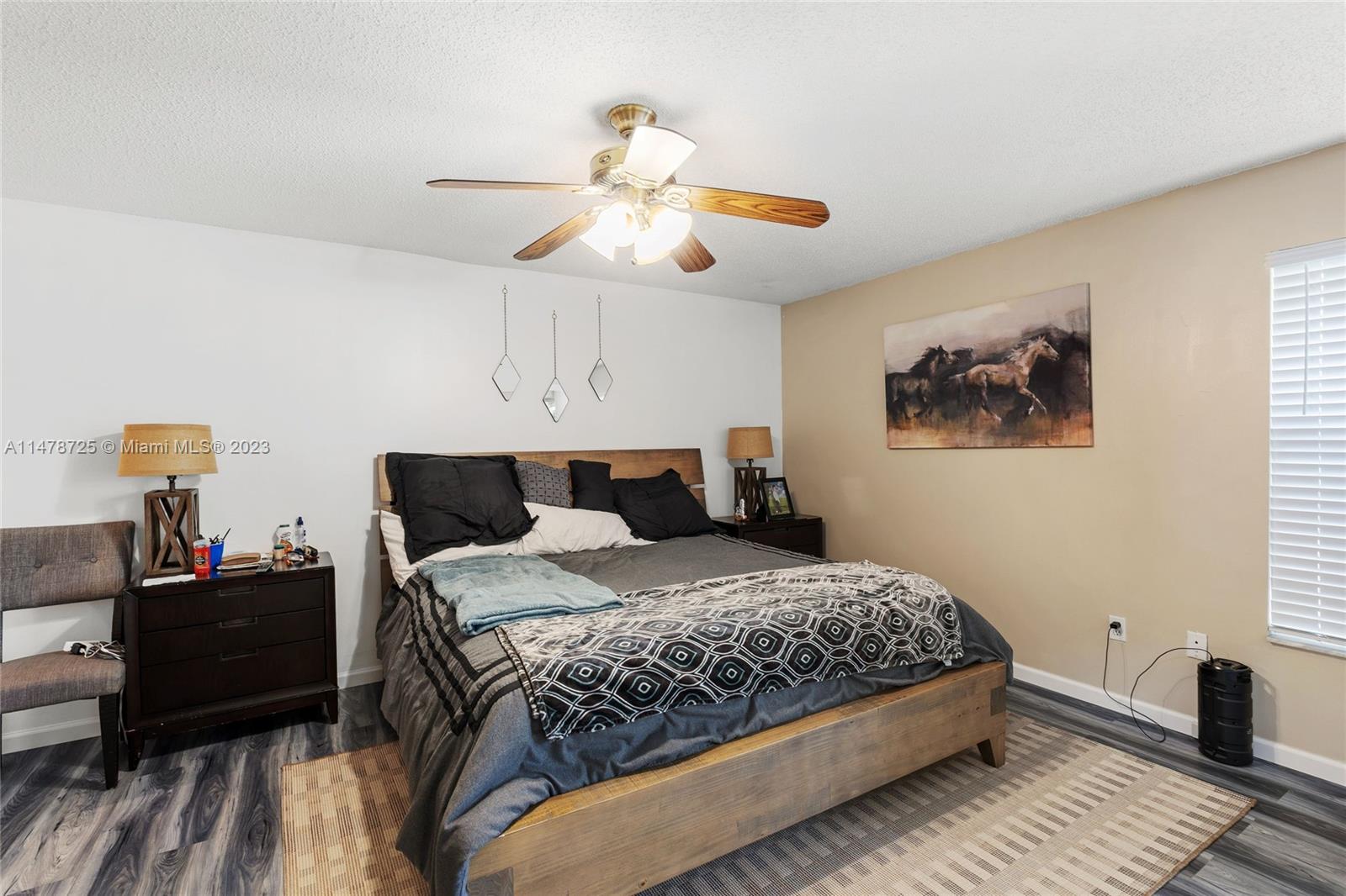 12722 Westhampton Circle Wellington, FL 33414 - Photo 33 of 52 a bedroom with a bed and wooden floor