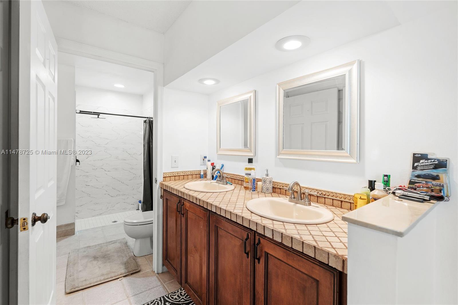 12722 Westhampton Circle Wellington, FL 33414 - Photo 35 of 52 a bathroom with a sink double vanity granite tub shower and a mirror