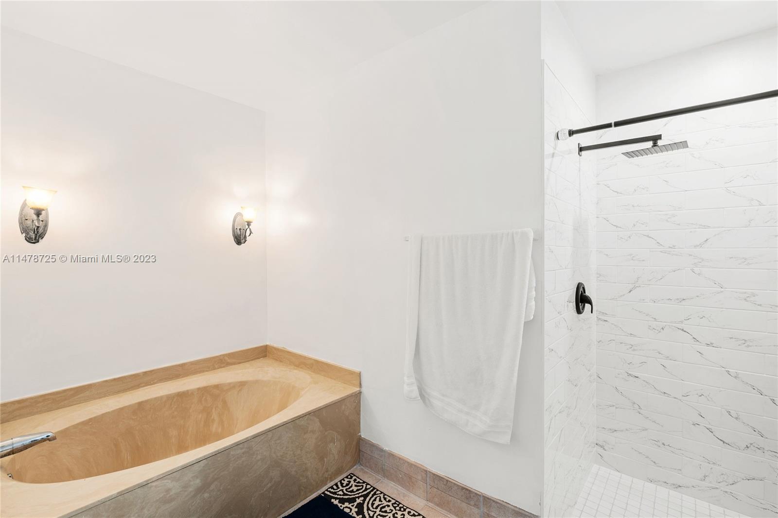 12722 Westhampton Circle Wellington, FL 33414 - Photo 36 of 52 a bathroom with a tub and shower