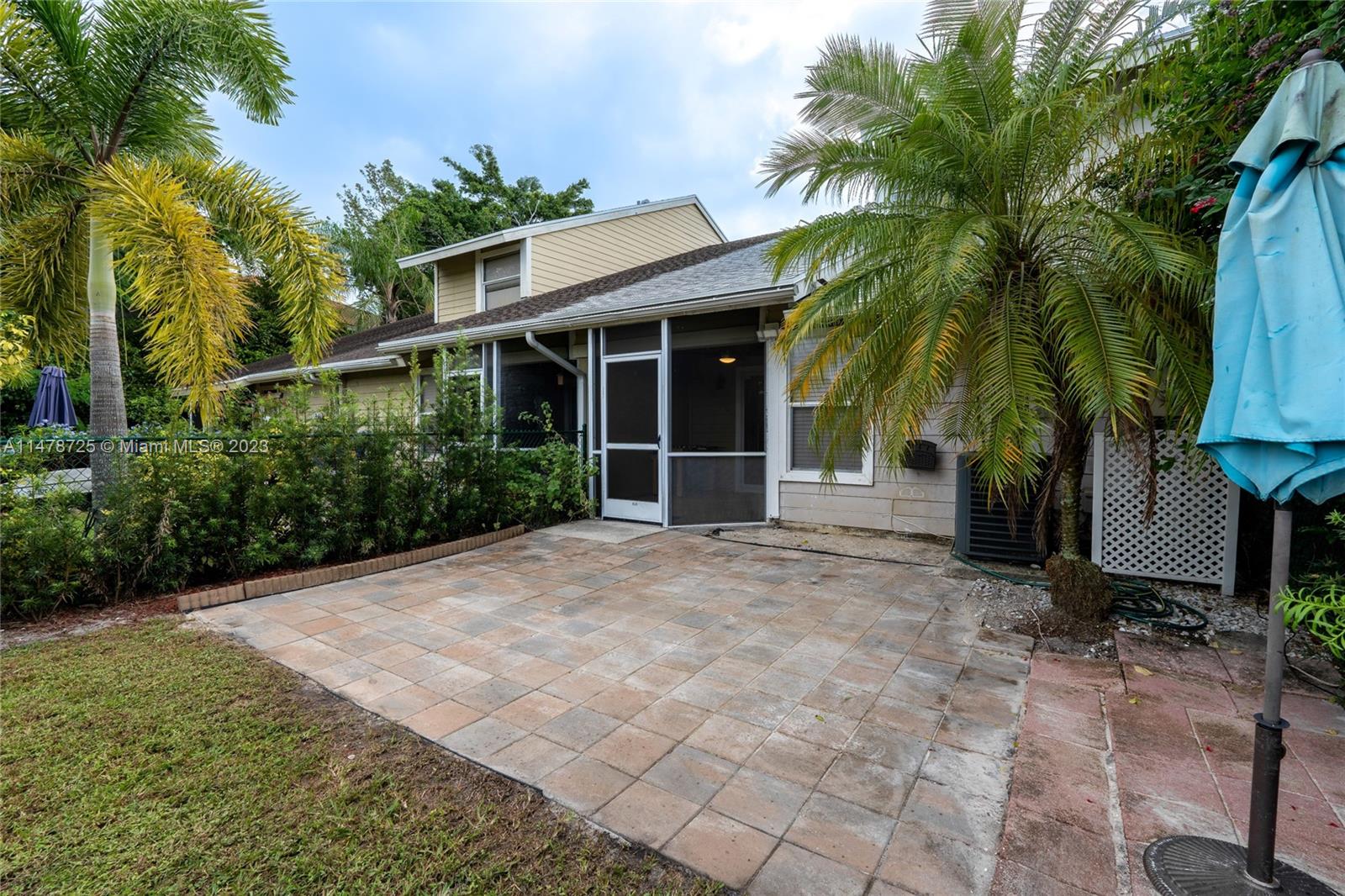12722 Westhampton Circle Wellington, FL 33414 - Photo 47 of 52 a view of a house with a yard and potted plants
