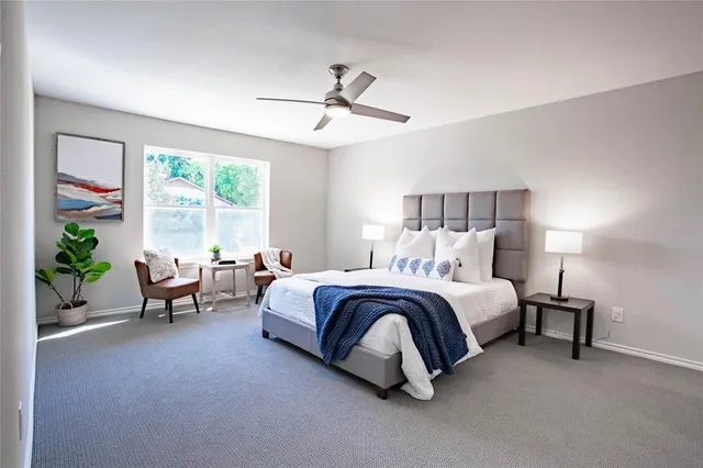 a spacious bedroom with a bed and a window