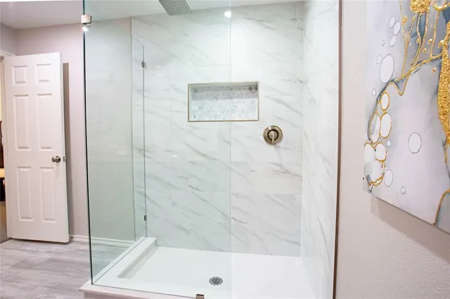 a bathroom with a bathtub and shower