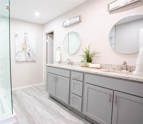 a bathroom with a double vanity sink and a mirror