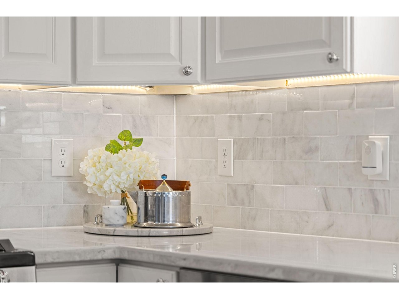636 Wild Ridge Circle Lafayette, CO 80026 - Photo 12 of 40 Elegant tile backsplash, sleek quartz surfaces, and built-in under-cabinet lighting