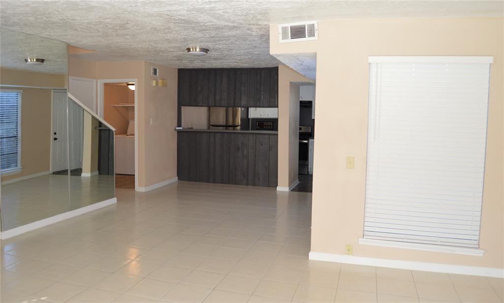 a view of a kitchen cabinets and an empty room