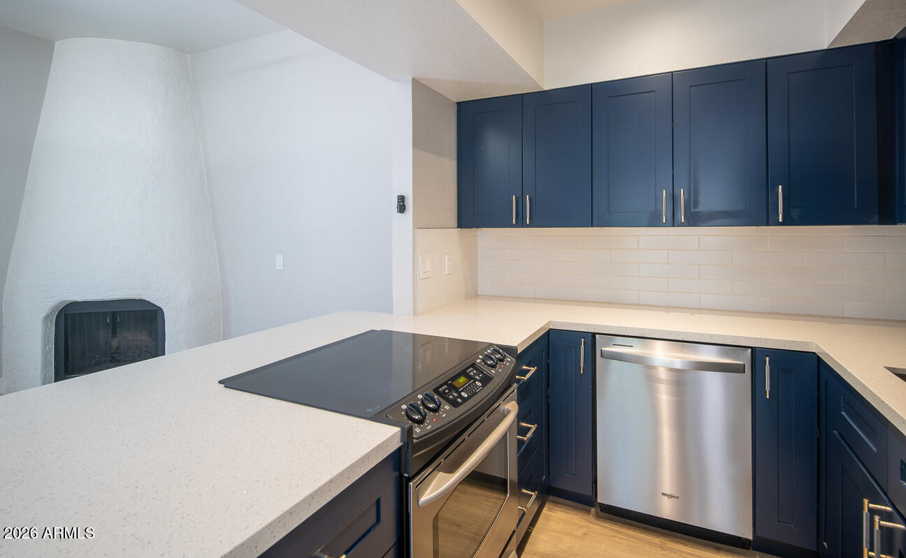 4540 North 44th Street, Unit 50 Phoenix, AZ 85018 - Photo 6 of 31 a kitchen with wooden cabinets and a stove top oven