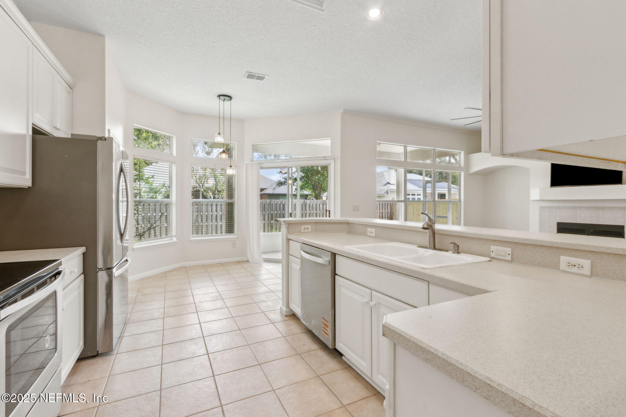 1912 Bluebonnet Way Fleming Island, FL 32003 - Photo 17 of 41 a kitchen with stainless steel appliances a refrigerator sink and microwave