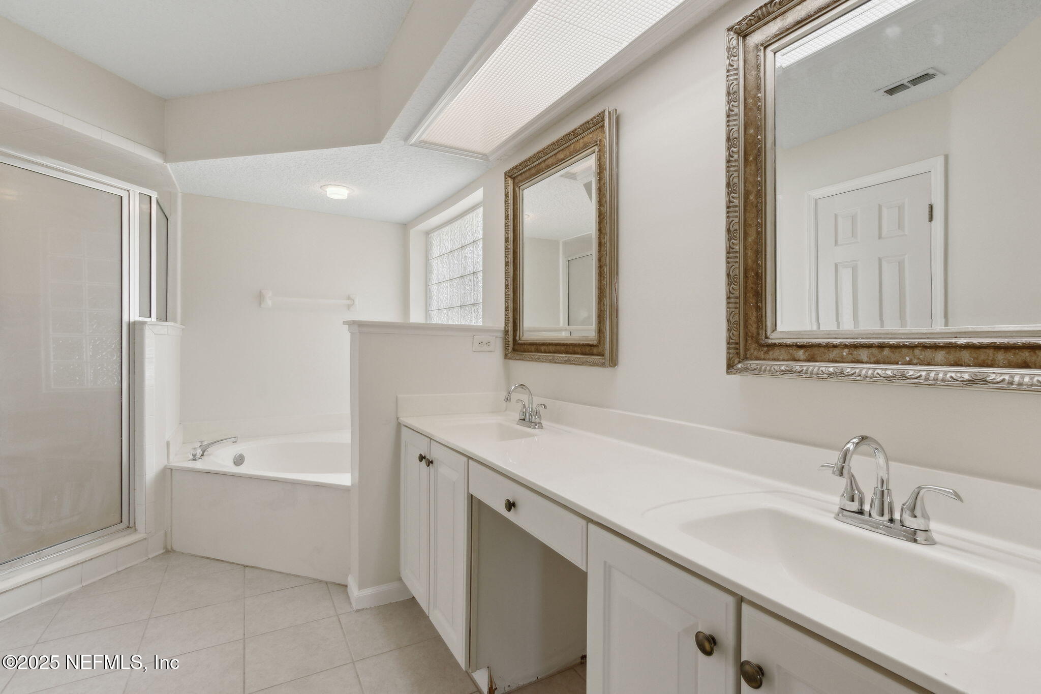 1912 Bluebonnet Way Fleming Island, FL 32003 - Photo 19 of 41 a bathroom with a sink a mirror and a bathtub