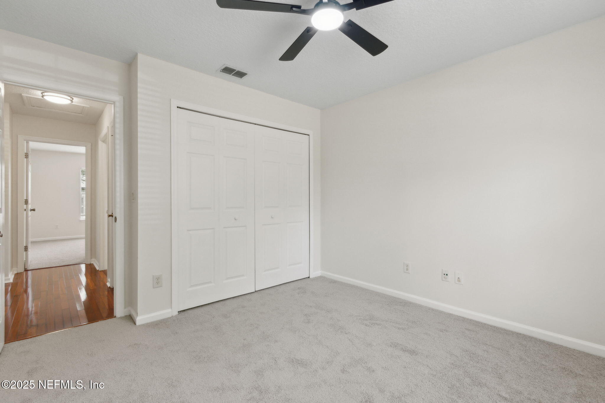 1912 Bluebonnet Way Fleming Island, FL 32003 - Photo 21 of 41 an empty room with a ceiling fan and carpet