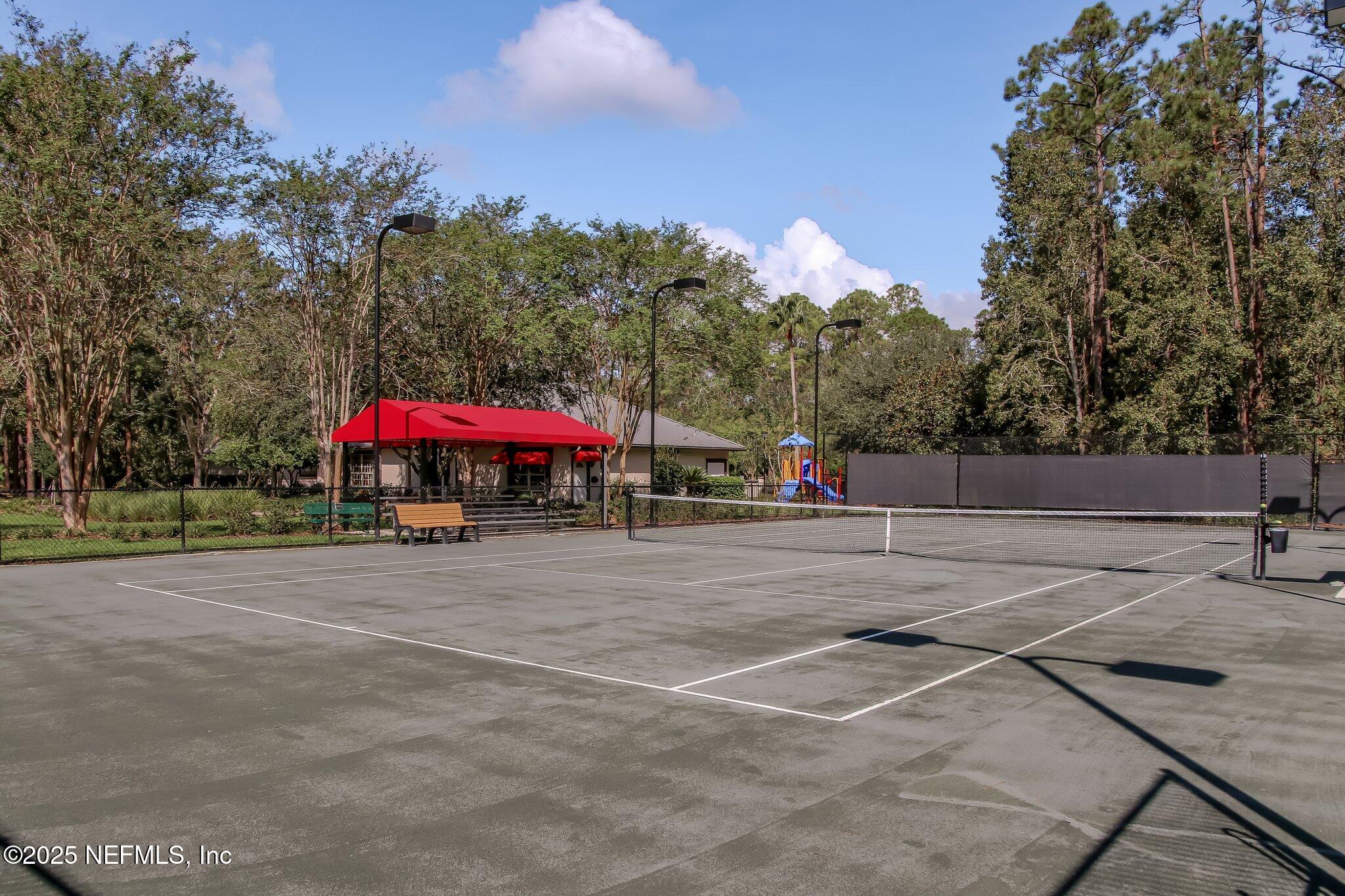 1912 Bluebonnet Way Fleming Island, FL 32003 - Photo 34 of 41 a view of a tennis ground with large trees