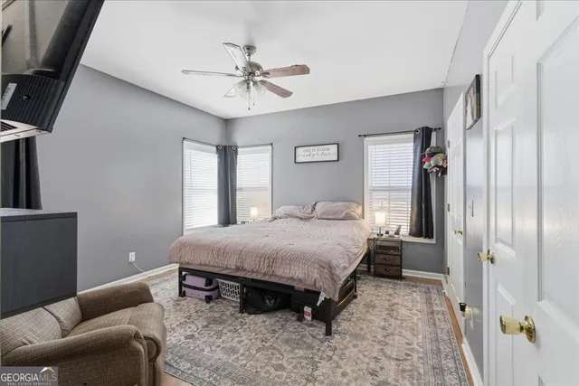 a bedroom with a bed and a flat screen tv