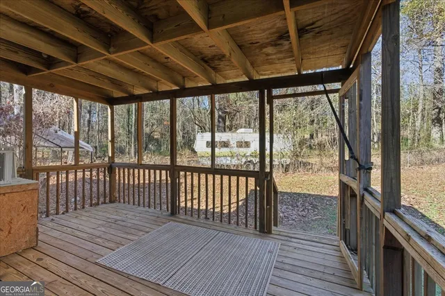 a view of a porch with wooden floor