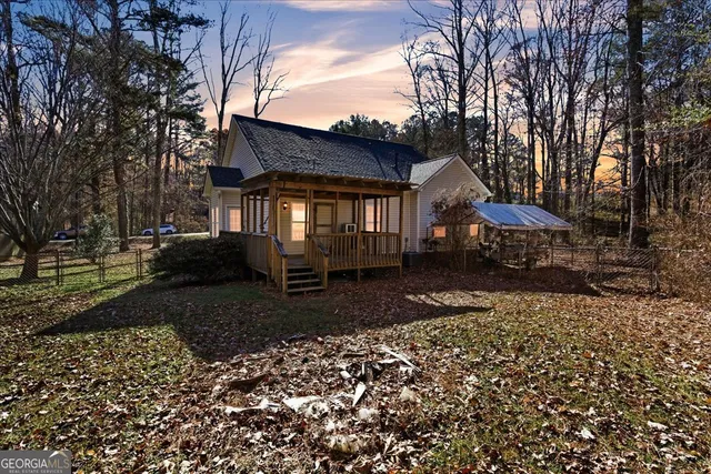 a view of a house with a yard covered with snow in the background