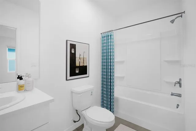 a bathroom with a tub sink and mirror