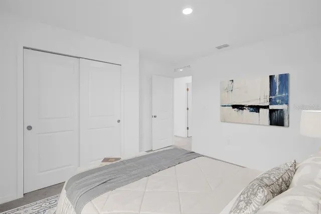 a bedroom with a bed and a couch