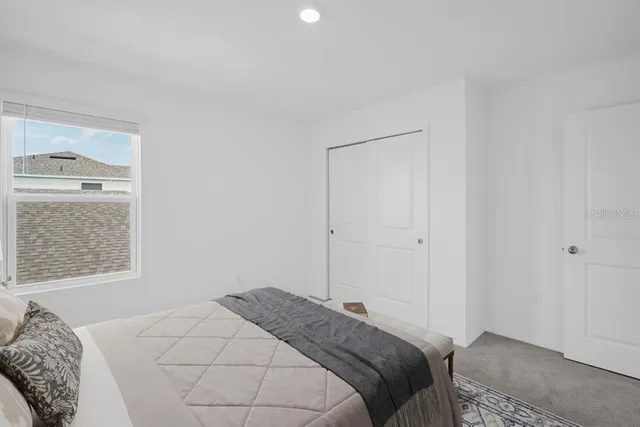 a bedroom with a bed and a wall painting