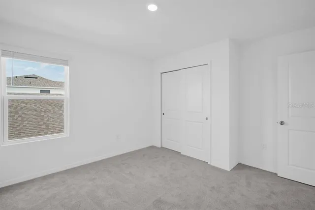 a white toilet sitting next to a bath tub