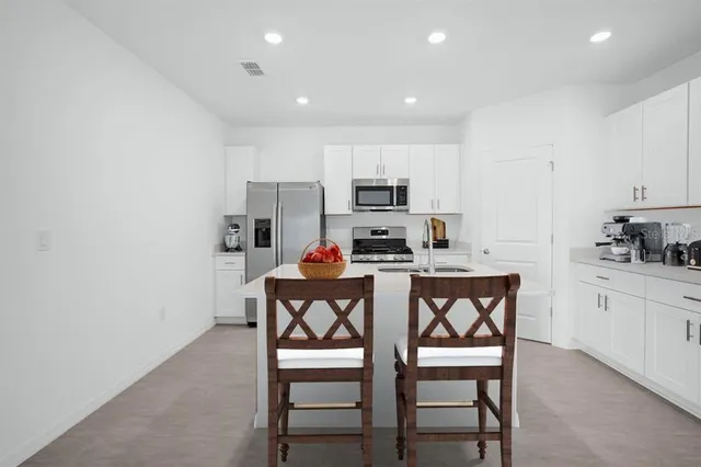 a dining room with furniture and wooden floor